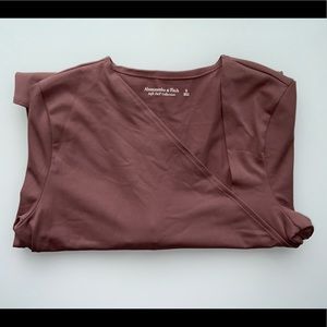 Neutral pink toned long sleeve bodysuit from the soft A & F collection